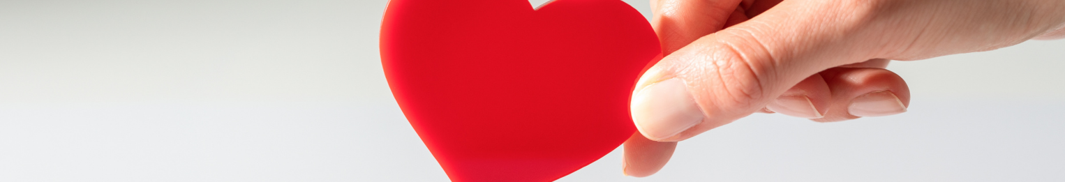 Image showing a hand holding a paper heart.