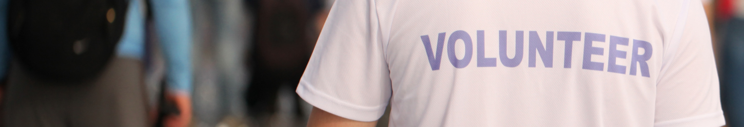 Photo of person wearing a t-shirt with the text Volnteer on it.